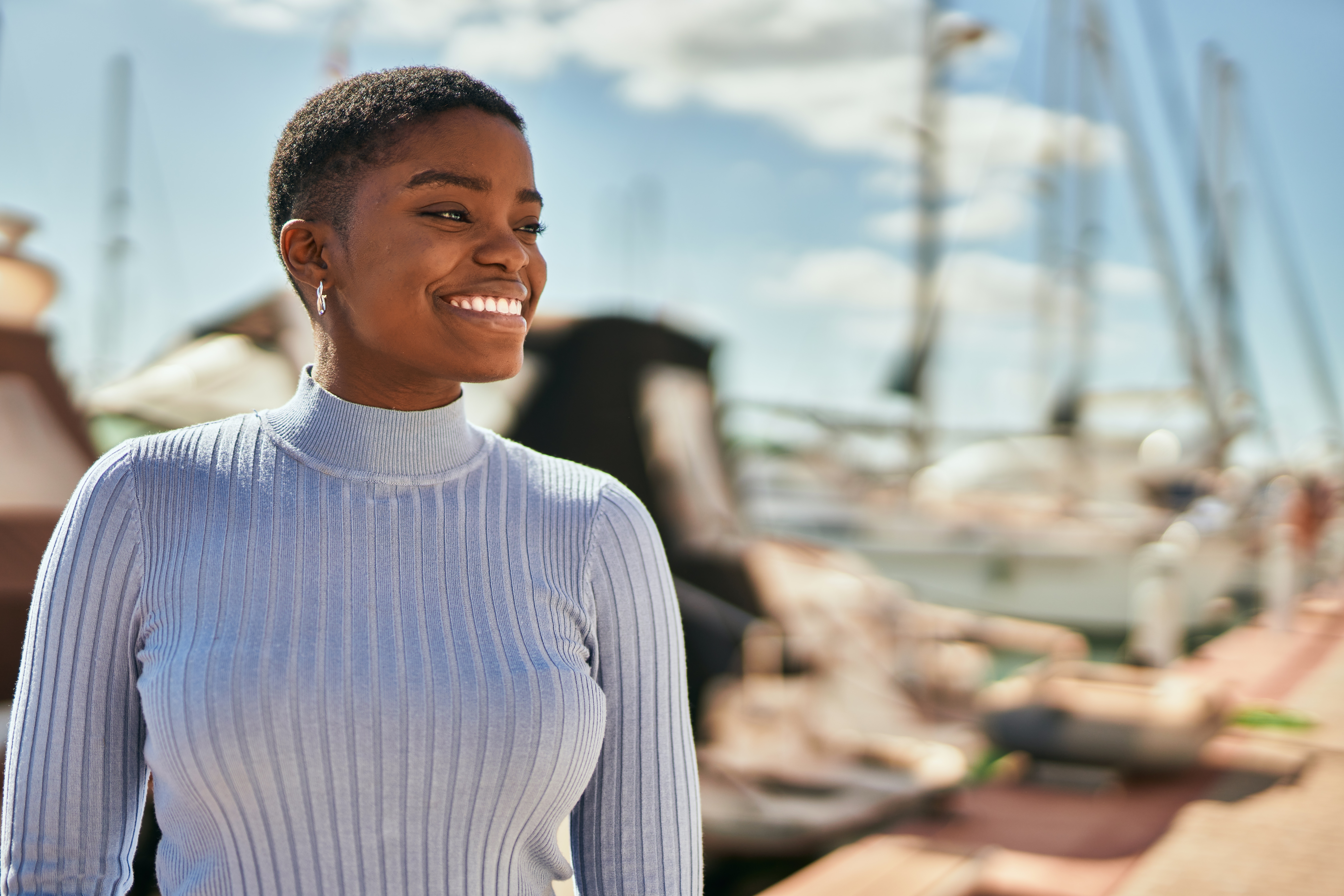 Young african american woman smiling happy standing at the port. About pdl